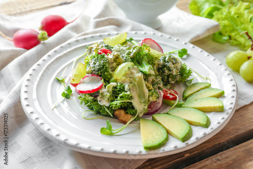 Plate with broccoli salad on table
