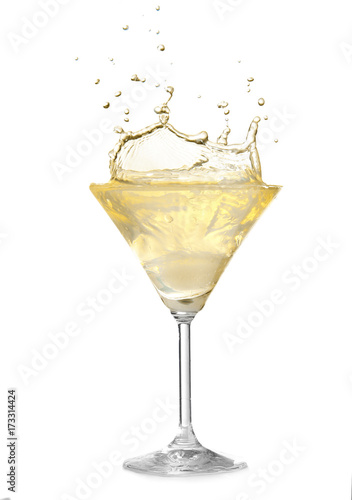 Glass of lemon drop martini with splash on white background