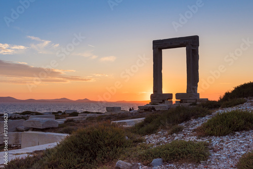 The Portara, one of Naxos most famous landmarks with overlooking the sunset. Cyclades Islands, Greece. 