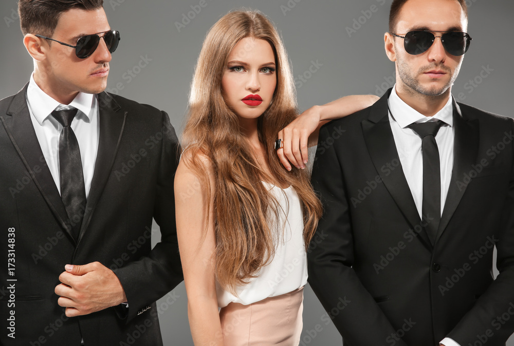 Famous celebrity with bodyguards on grey background Famous celebrity with bodyguards on grey background