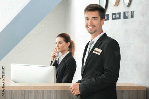 Male receptionist working i...