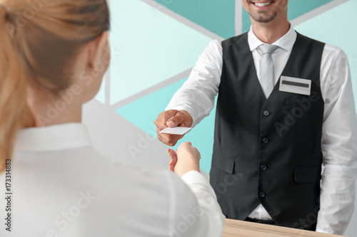 Male receptionist giving ke...