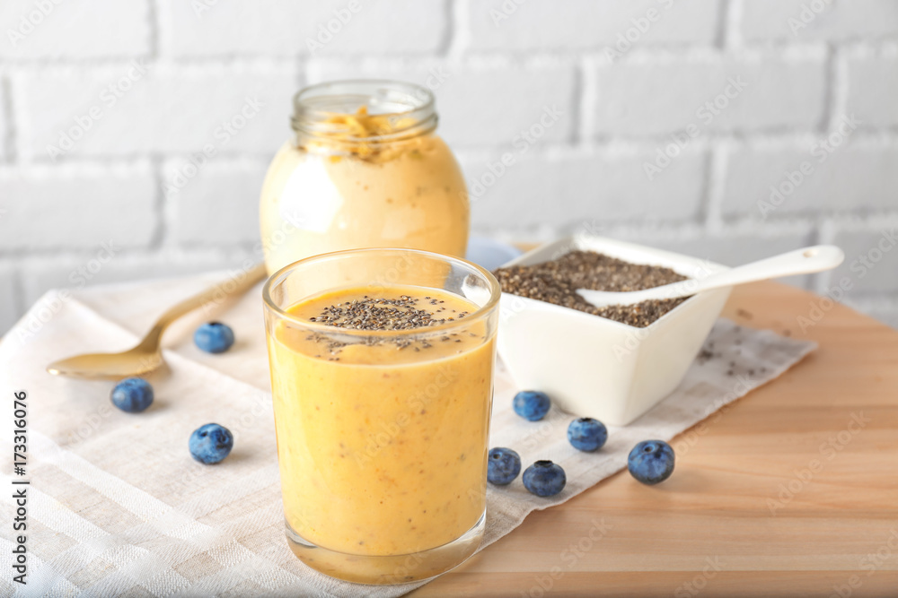 Glass of delicious smoothie with chia seeds on table Glass of delicious smoothie with chia seeds on table