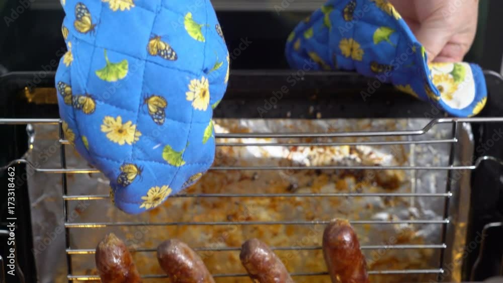 Cooking beef sausages roasted in the oven with broiler. View from above