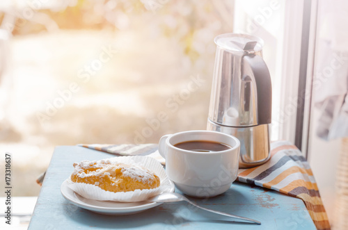 Breakfast on table against opened window