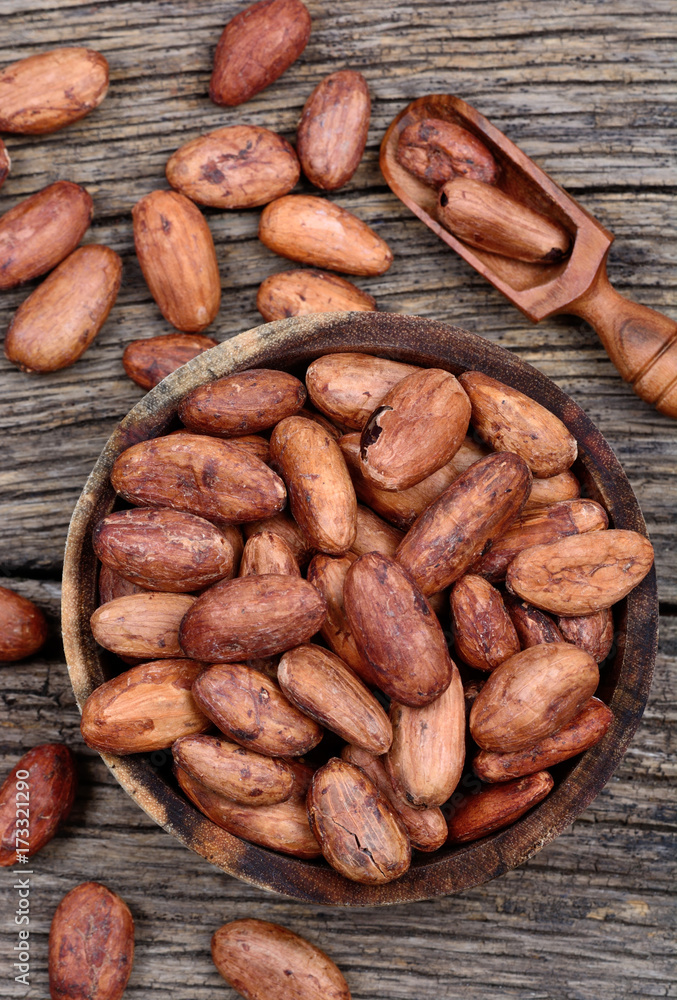 Cacao beans in a bowl on table Cacao beans in a bowl on table