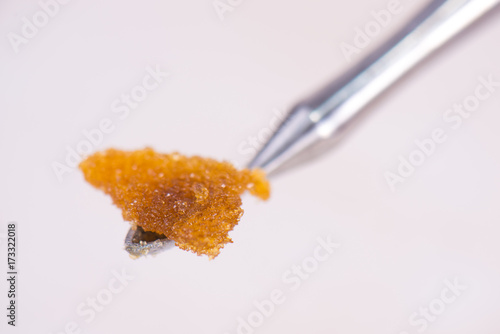 Dannabis concentrate live resin (extracted from medical marijuana) isolated over white