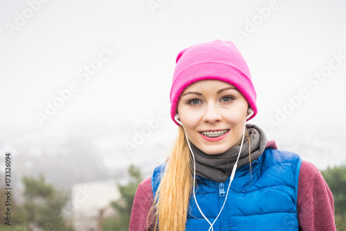 Woman wearing sportswear exercising outside during autumn