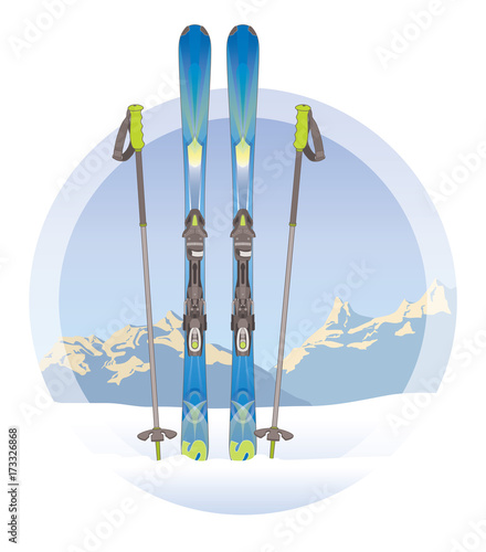 pair of skis and ski poles on snow with mountains in the background
