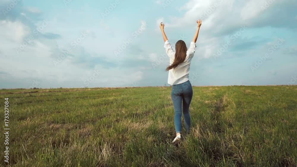 Young beautiful woman walking in the field