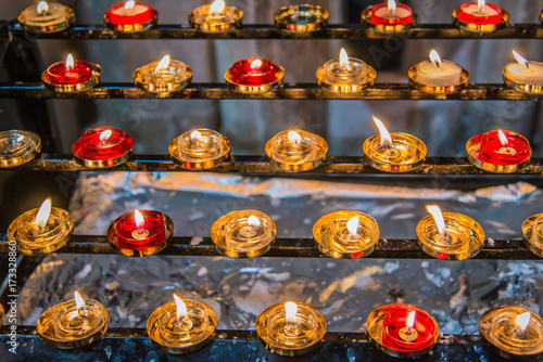 Red and Gold Prayer Candles in Church