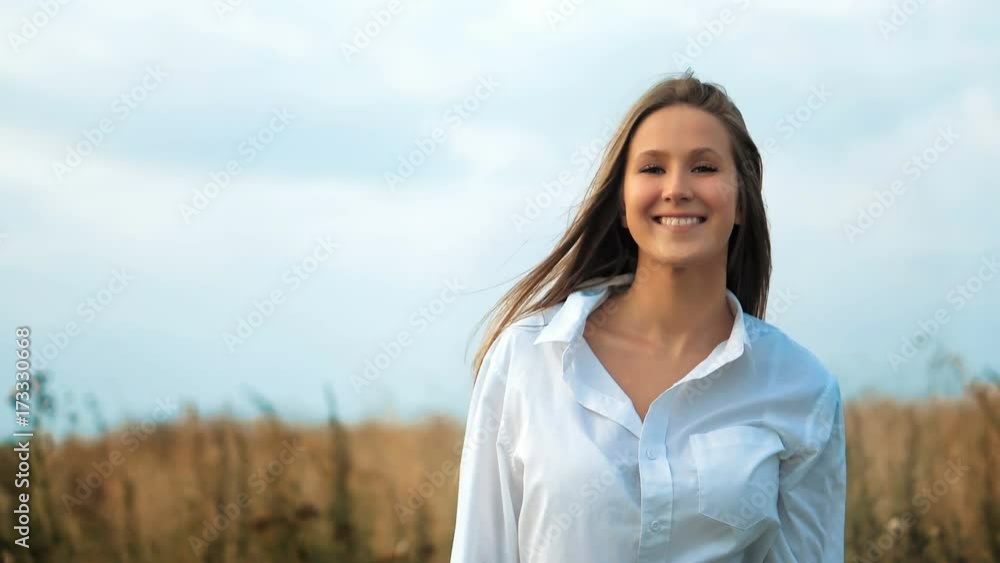 Young beautiful woman posing in a golden field Young beautiful woman posing in a golden field