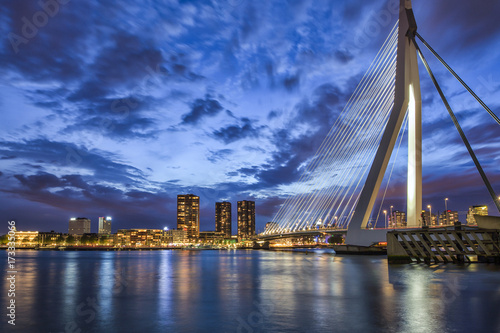Travel Ideas. Picturesque View of Erasmusbrug (Erasmus Bridge) in Rotterdam at Twilight. Cityscape Image of Rotterdam in The Netherlands During Blue Hour.