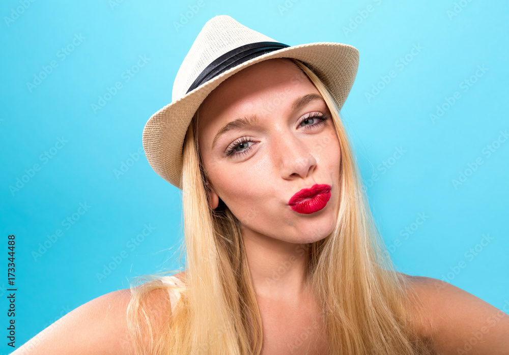 Young woman taking a selfie on a solid background Young woman taking a selfie on a solid background