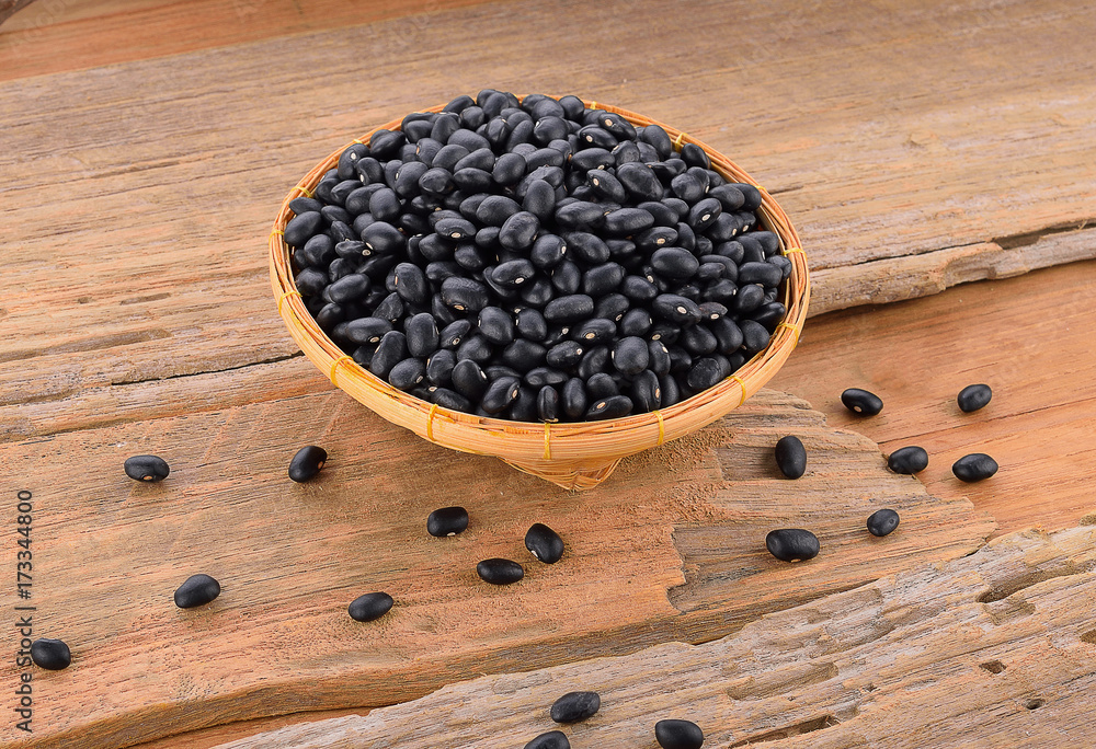 Black bean on wooden floor Black bean on wooden floor