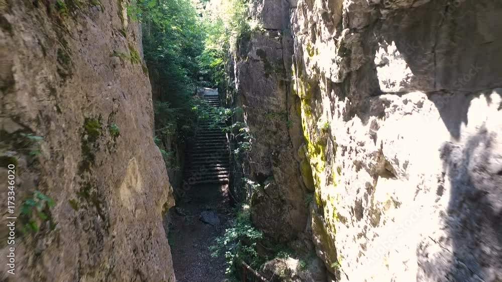 Flying camera aerial between rocks in canyon. Flying camera aerial between rocks in canyon.