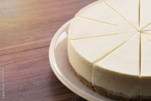 Photos Half cream cake on wood table
