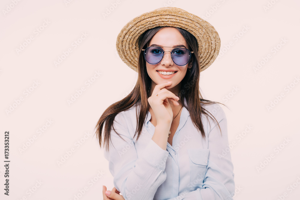 young girl posing in hat and glasses in the whit wall young girl posing in hat and glasses in the whit wall