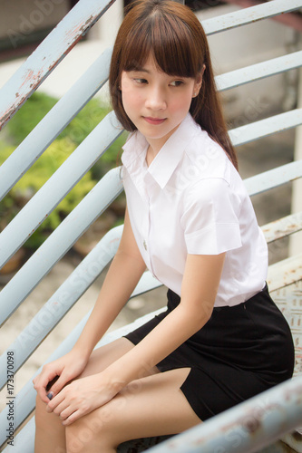 Portrait of thai adult student university uniform beautiful girl relax and smile © tiniroma