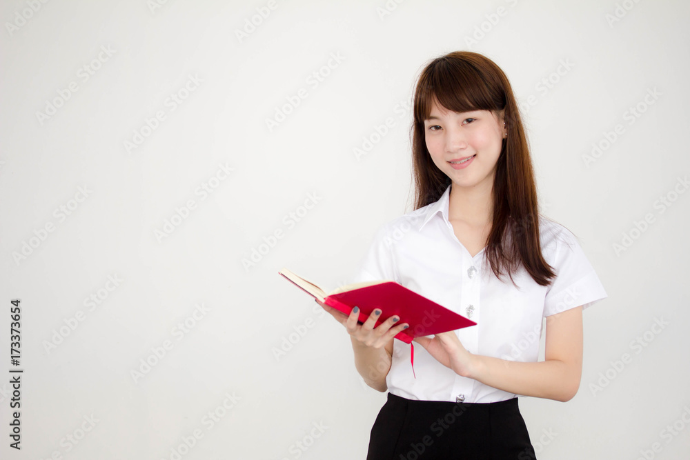 Portrait of thai adult student university uniform beautiful girl read red book Portrait of thai adult student university uniform beautiful girl read red book