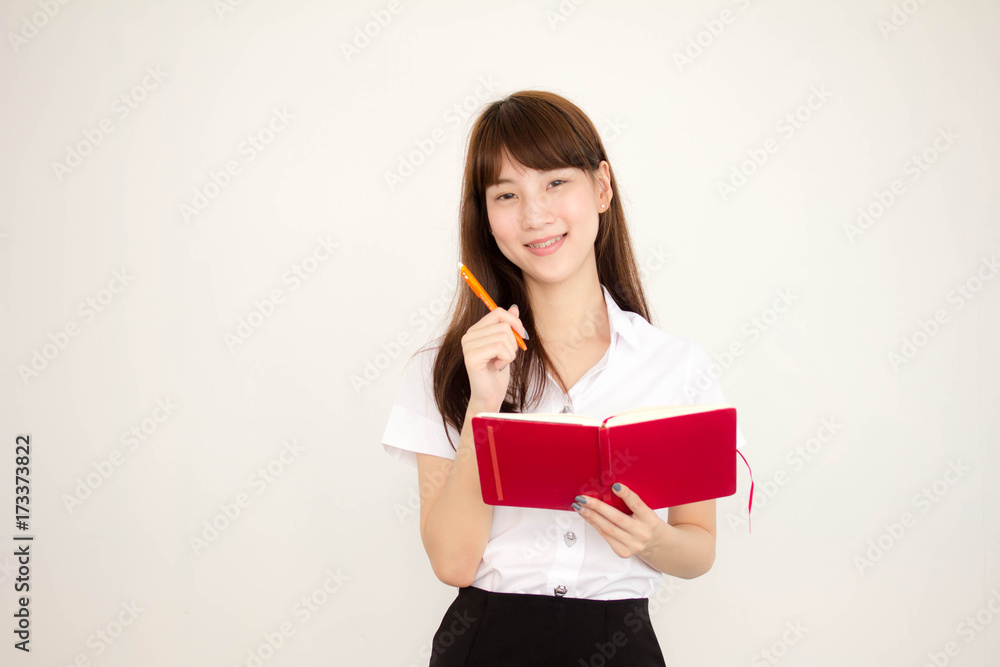 Portrait of thai adult student university uniform beautiful girl read red book Portrait of thai adult student university uniform beautiful girl read red book