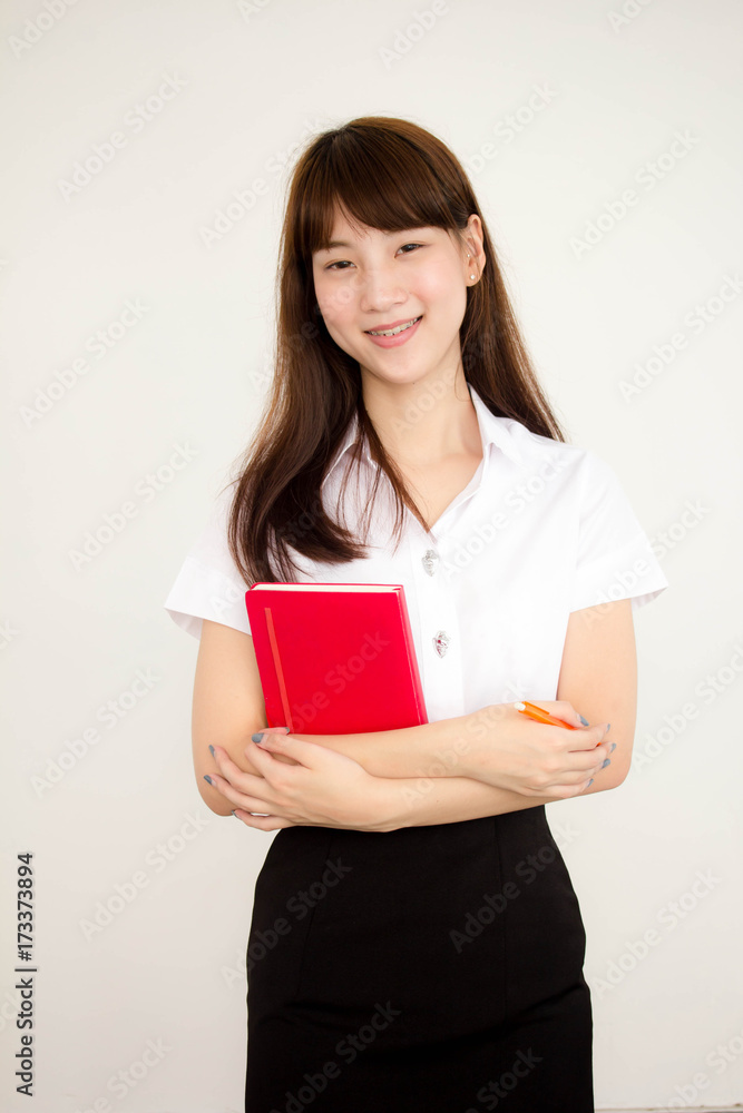 Portrait of thai adult student university uniform beautiful girl read red book Portrait of thai adult student university uniform beautiful girl read red book