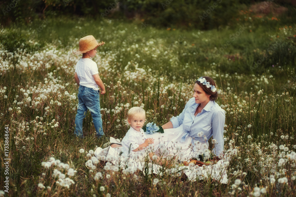 Fototapeta premium mother and two sons at the picnic .Happy family on summer vacation