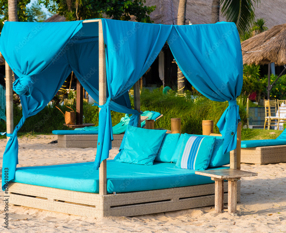 Turquoise sunbeds on the beach in Bali, Indonesia Stock Photo | Adobe Stock