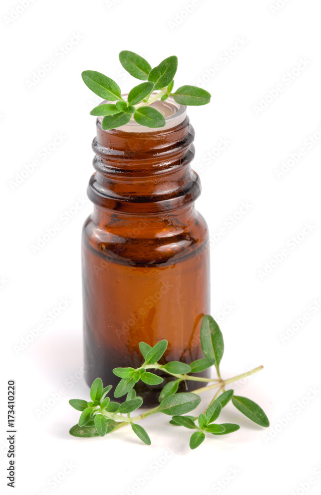 Bottle of essential oil with herbs thyme isolated on white background Bottle of essential oil with herbs thyme isolated on white background