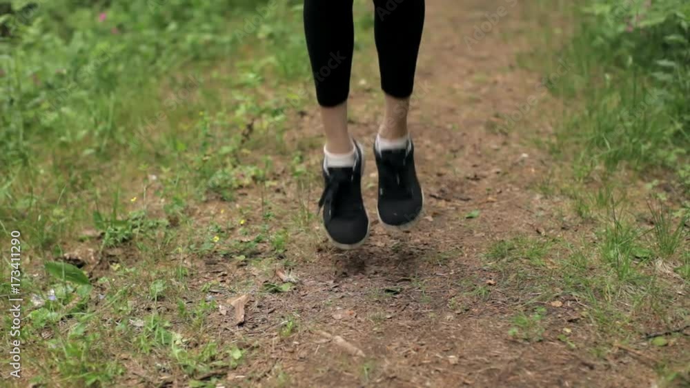 Close-Up. Legs of a Girl Jumping Rope in the Forest Close-Up. Legs of a Girl Jumping Rope in the Forest