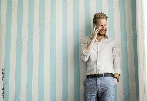 Young man with a phone by t...