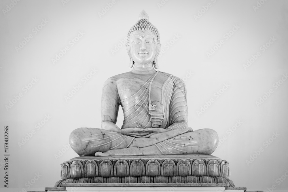 Fototapeta premium Marble buddha image on white background.Buddha statue in Buddhist temple or wat, is public domain or treasure of Buddhism. (Shot at outdoor ,public area)