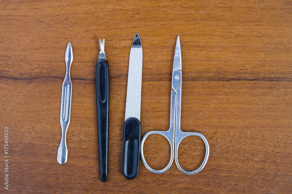 Basic set of manicure tools on wooden background