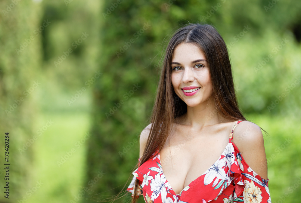 Outdoors portrait of beautiful brunette girl looking at camera Outdoors portrait of beautiful brunette girl looking at camera