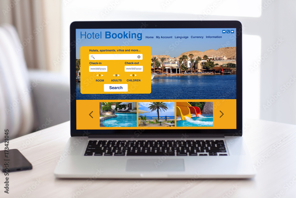 laptop with hotel booking screen on table in room laptop with hotel booking screen on table in room