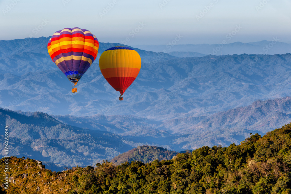 Colorful hot-air balloons flying over the Doi Luang Chiang Dao with sunrise and morning mist at Chiang mai, Thailand.