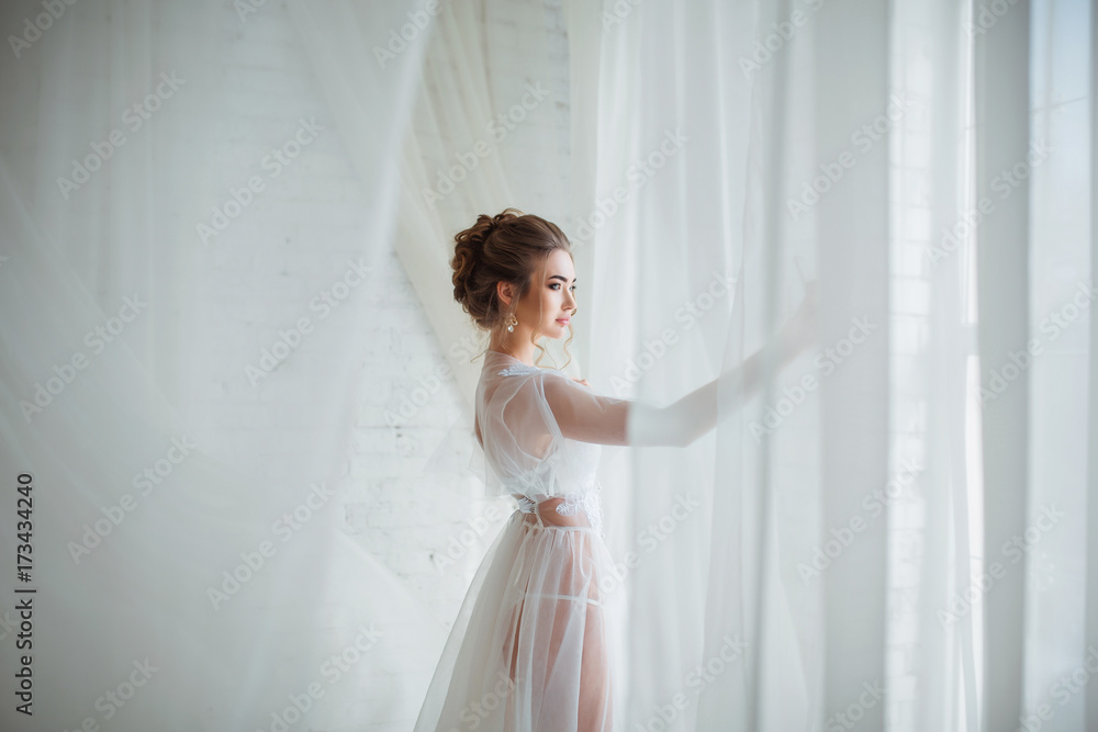 Beautiful girl relaxing in light white bedroom in a sensual way. Perfect, sexy body, legs and ass of young woman wearing seductive lingerie. Beautiful girl relaxing in light white bedroom in a sensual way. Perfect, sexy body, legs and ass of young woman wearing seductive lingerie.