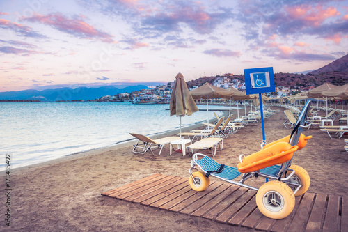 Fototapeta Naklejka Na Ścianę i Meble -  Beach wheel chair for disabled swimmers, Elounda, Crete, Greece