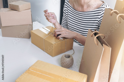 Internet online shopping concept, Young seller woman preparing package to be sent Mail transportation, service network connection market, technology on global, Order online for customer convenience © Freedomz