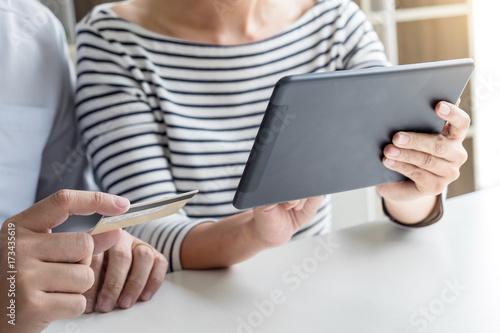 Two people using tablet and credit/debit card register payments online shopping and customer service network connection market, using technology on global, Internet Online shopping or banking concept