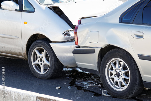 Two cars in a car accident on street. Closeup damaged automobiles after collision in city. © mark_ka