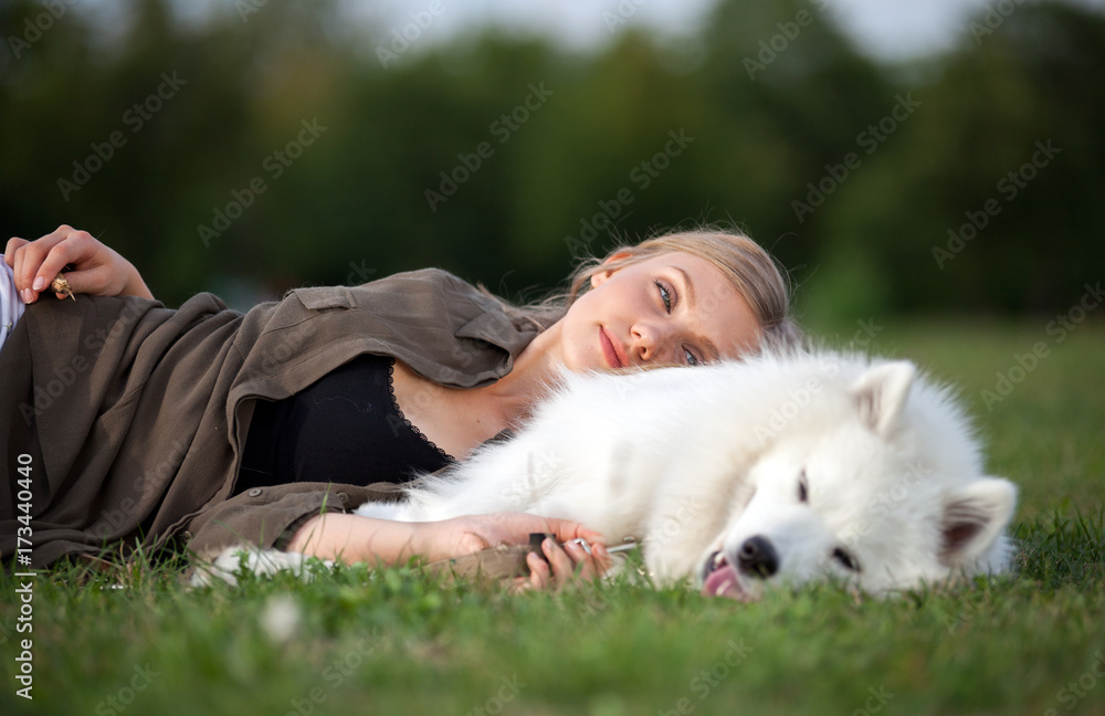 Relaxed pretty girl lying on dog at park Relaxed pretty girl lying on dog at park