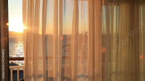 View of the sea and palm tree from a hotel room