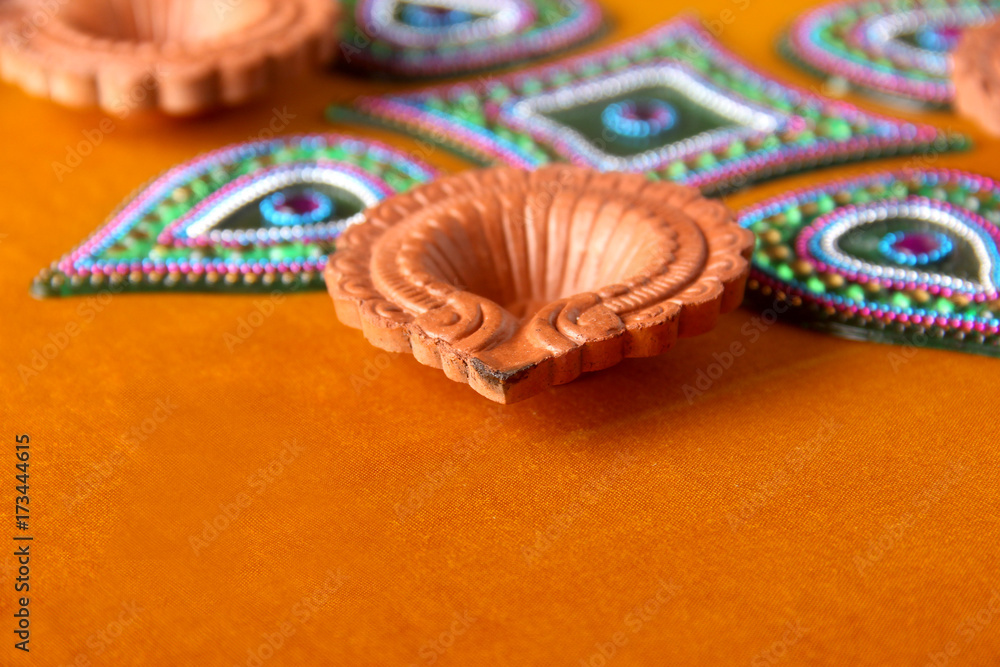 Fototapeta premium Rangoli design around Diwali lamp Indian Festival
