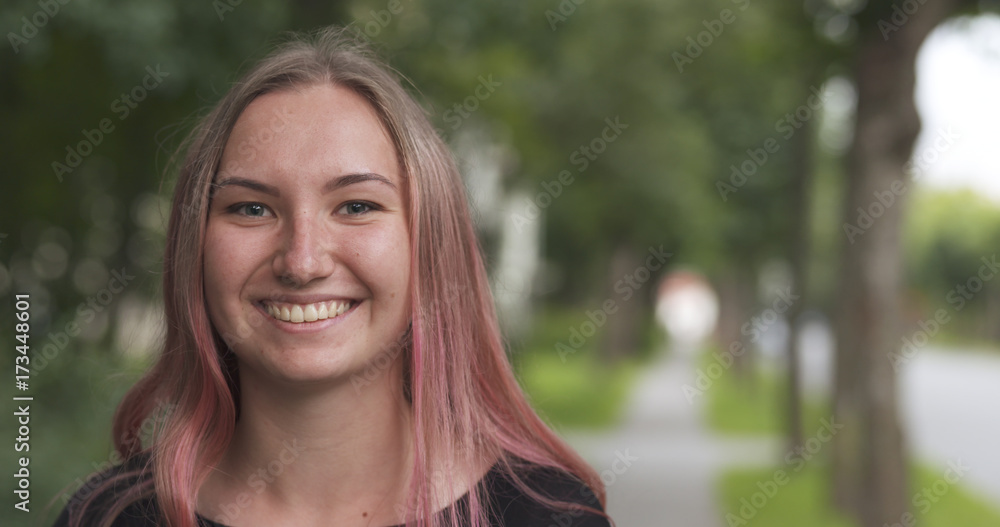 teen girl go closer to cam on sidewalk in town and wind blows her hair teen girl go closer to cam on sidewalk in town and wind blows her hair