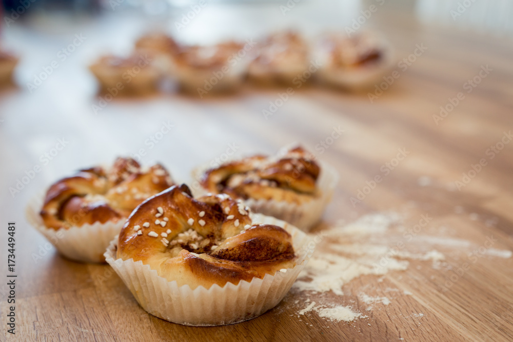 Cinnamon buns on wooden table close up Cinnamon buns on wooden table close up