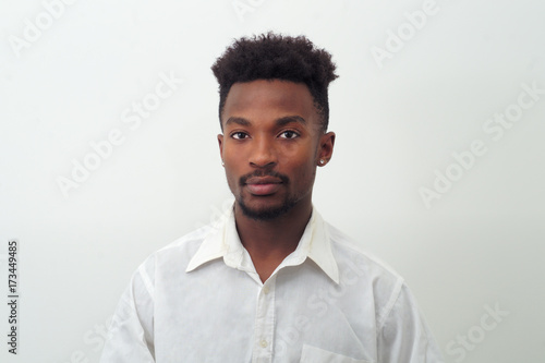 young man around twenty wearing white shirt studio white background