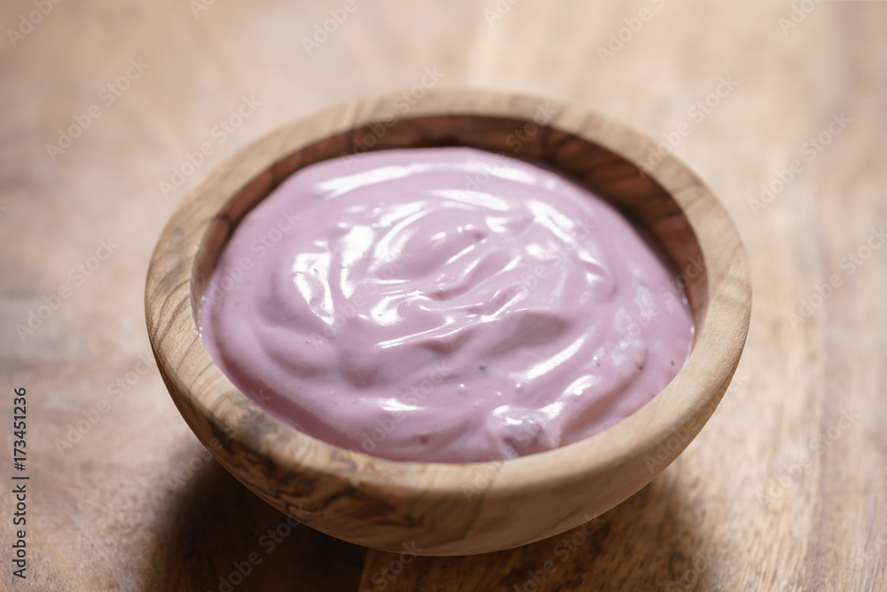 blueberry yogurt in wood bowl blueberry yogurt in wood bowl