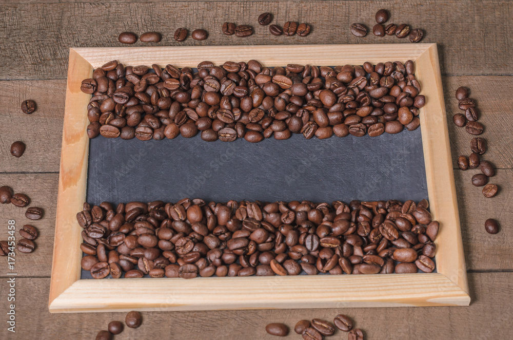 Coffee beans in a wooden frame on a wooden background top view Coffee beans in a wooden frame on a wooden background top view