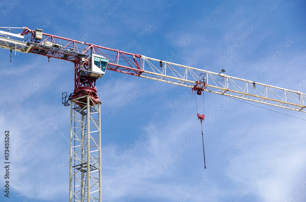Part of a construction tower crane against the blue sky, copy space Part of a construction tower crane against the blue sky, copy space